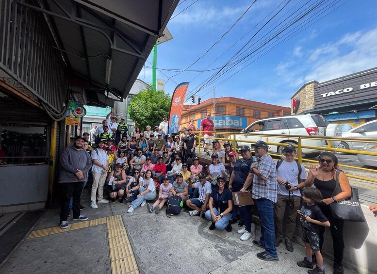 A group of people gathered outside a building with a sign that reads "TACO BELL". 1