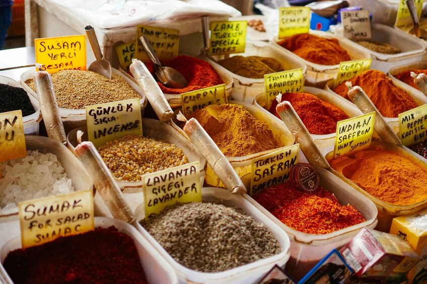 A variety of spices in containers with labels, including sumak, lavanda, and curry. 4