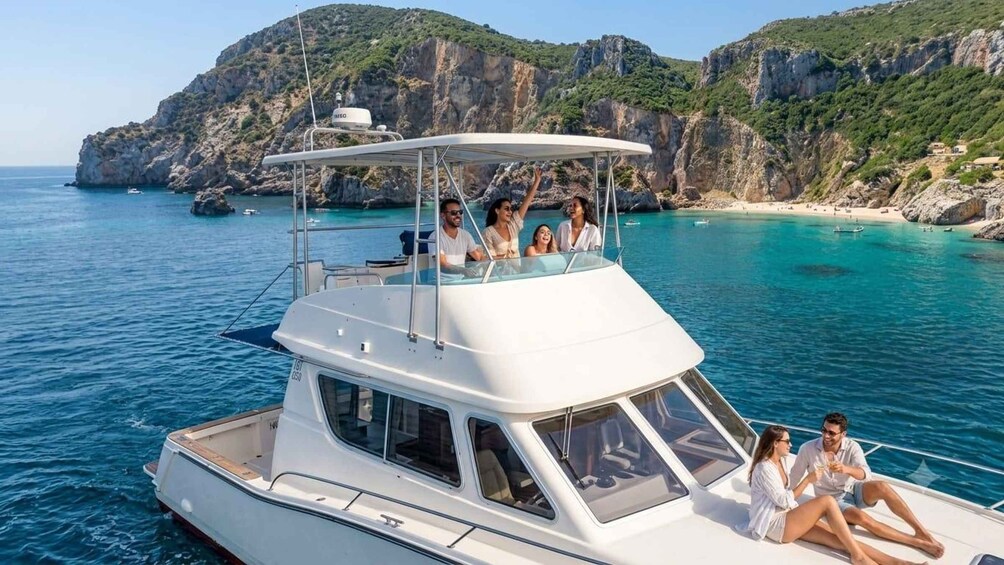 A white boat with passengers on a clear day, surrounded by turquoise water and rocky cliffs. 2
