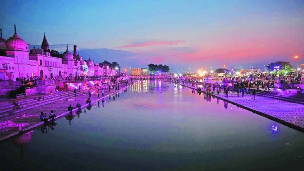 A river with a reflection of buildings and a crowd of people. 3