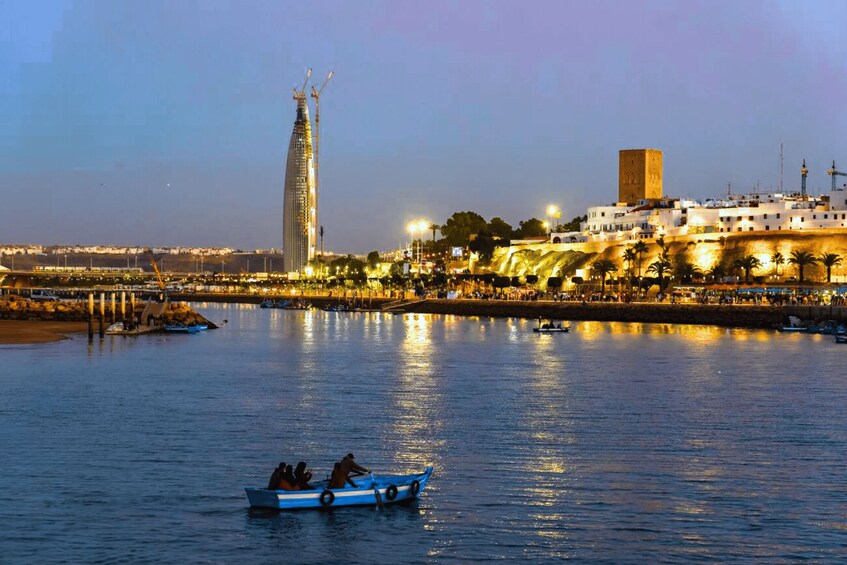 A river with a boat, a tall building, and a historic fort. 1