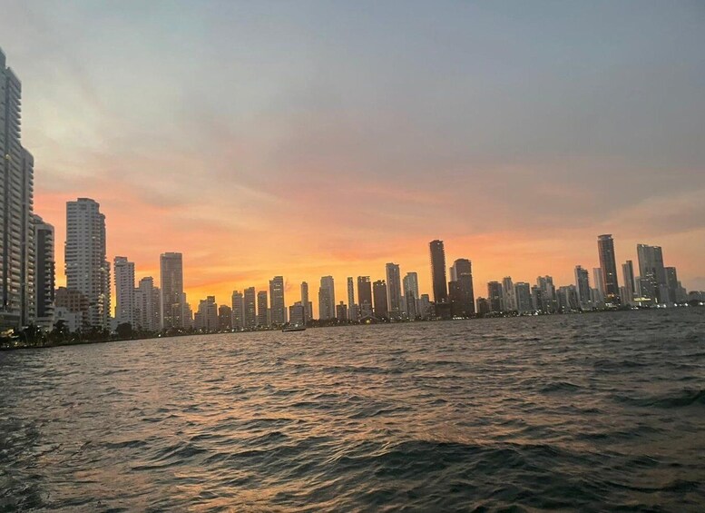 A city skyline at sunset with high-rise buildings along a waterfront. 4