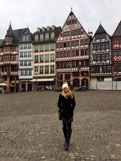 A cobblestone square with traditional half-timbered buildings. 5