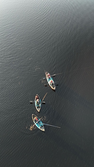 Three small boats on a calm body of water. 2