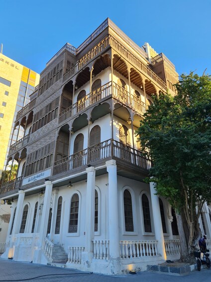 A multi-story building with ornate balconies and arched windows. 5