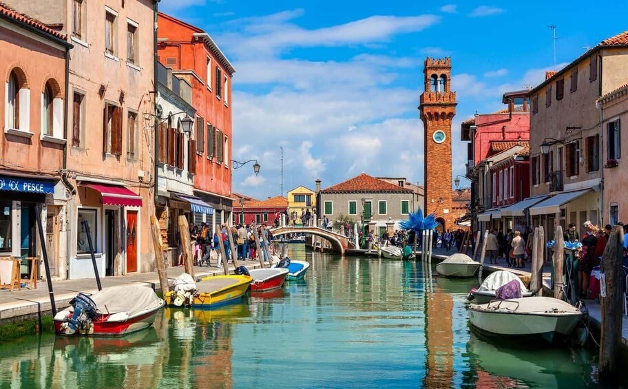A canal with boats, a bridge, and historic buildings. 2