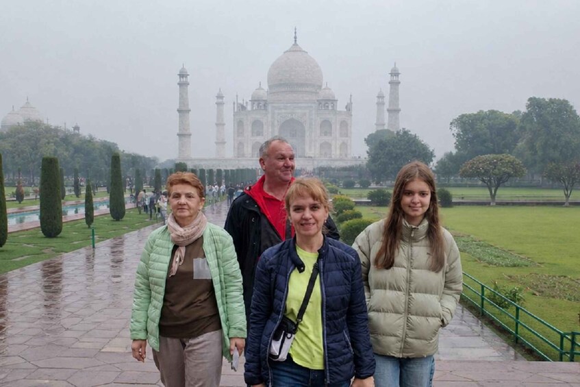 A group of people standing in front of the Taj Mahal. 3