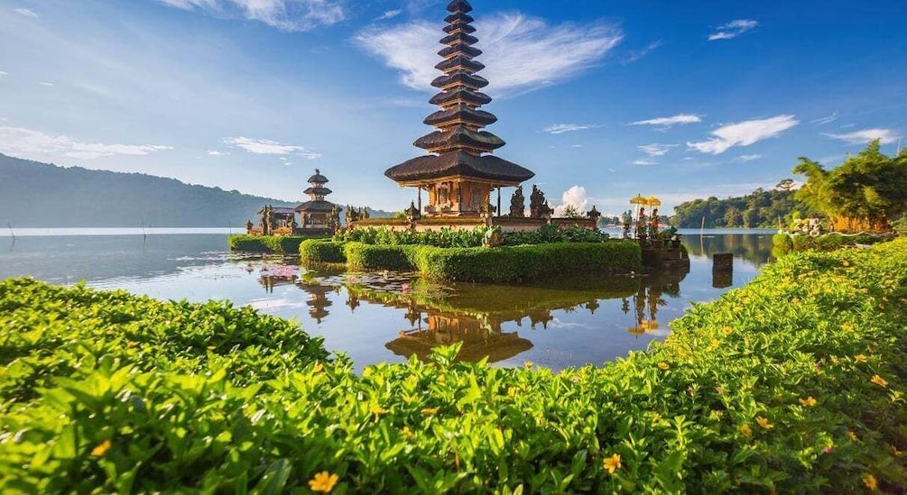 A pagoda-style temple surrounded by water and greenery. 3