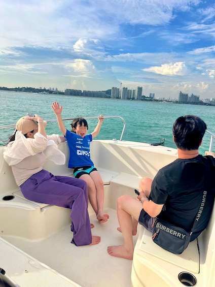 Three people on a boat with a city skyline in the background. 4