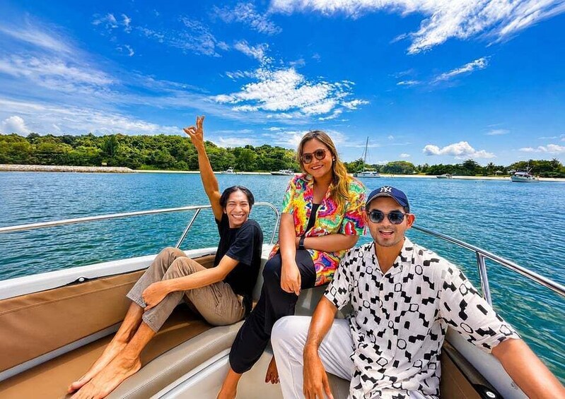 Three people on a boat with a clear blue sky and calm water. 5