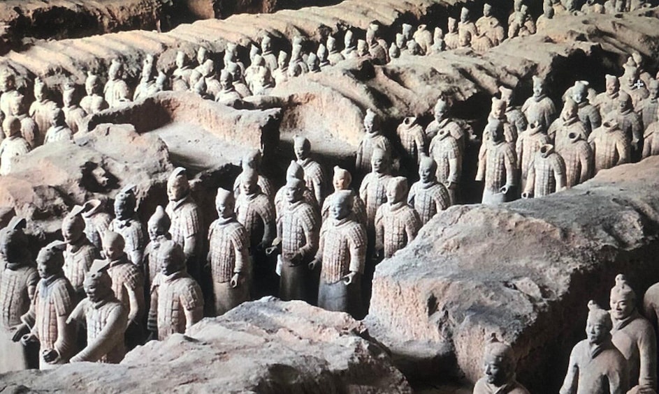 A large number of stone statues arranged in rows. 3
