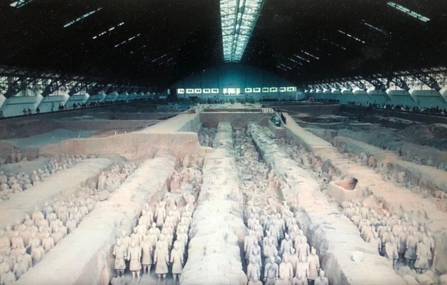 A large, open-air structure with rows of terracotta soldiers. 1