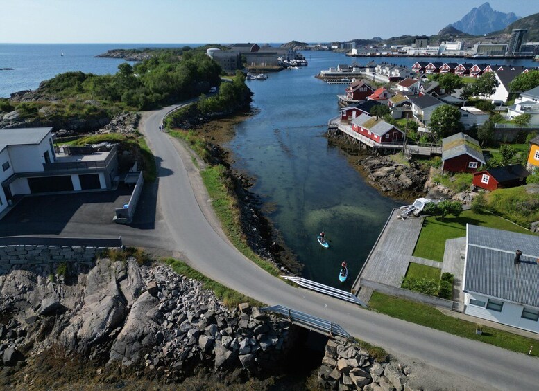 A coastal town with a river, houses, and a bridge. 4