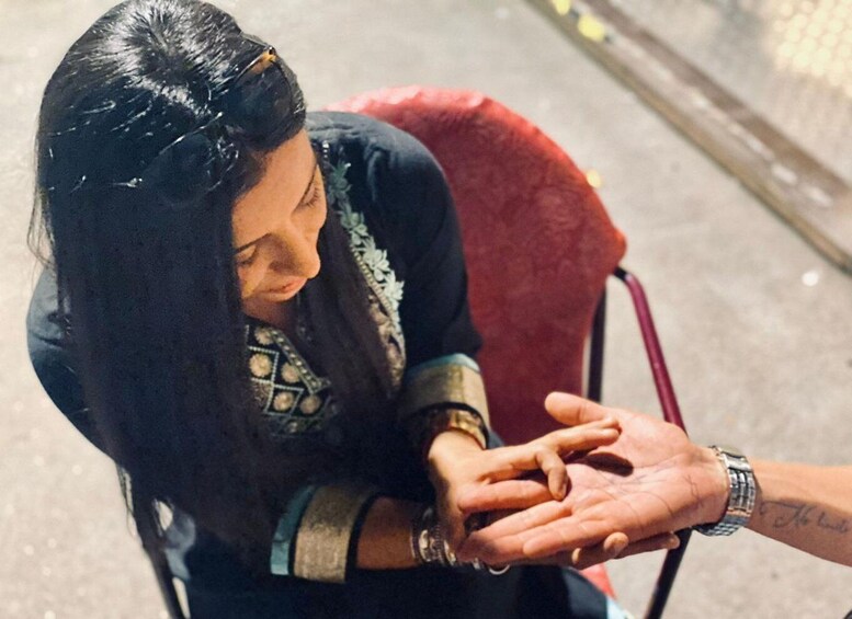 A person in a wheelchair with a hand extended towards another person. 1