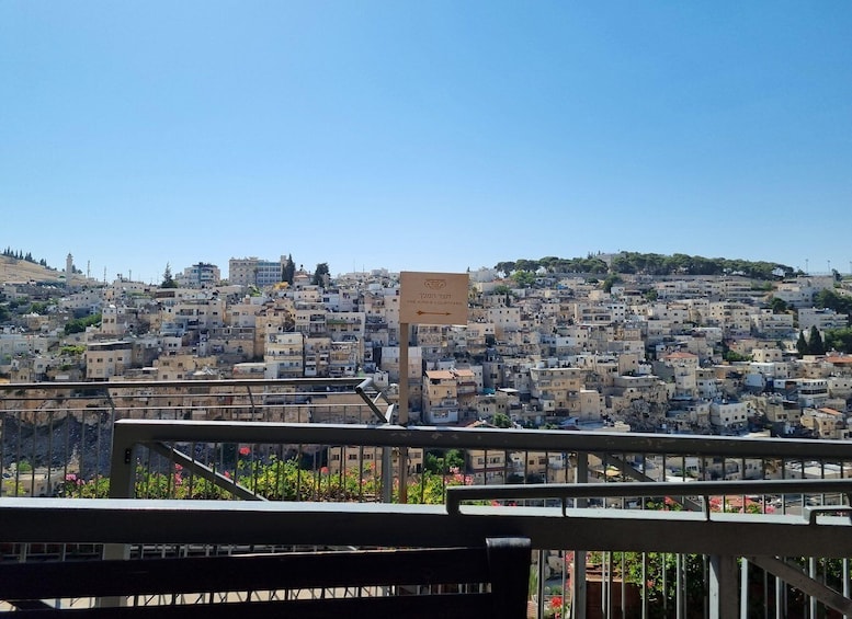 A densely packed hillside cityscape with a sign indicating 'King's Courtyard'. 1