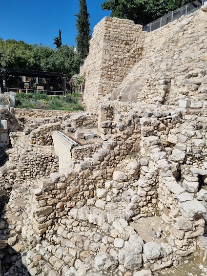 Ancient stone ruins with a partially intact wall and scattered rubble. 3