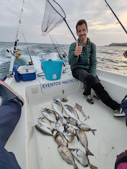 A boat with fishing rods and a net, and several fish on the deck. 4