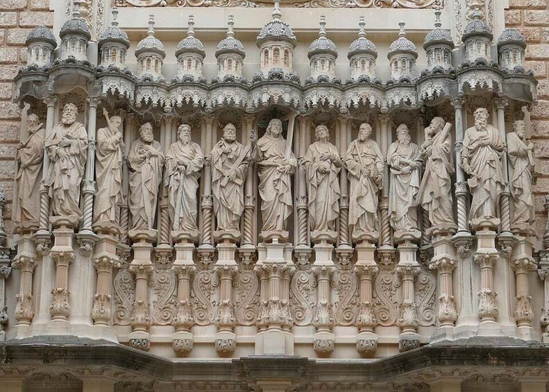 A detailed stone facade with statues and ornate architectural elements. 3