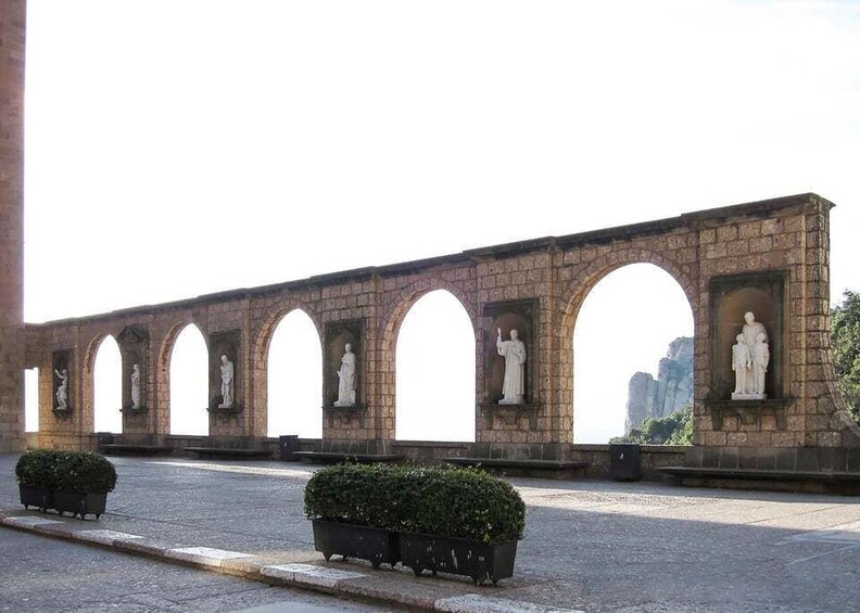 A stone bridge with statues in the arches. 2