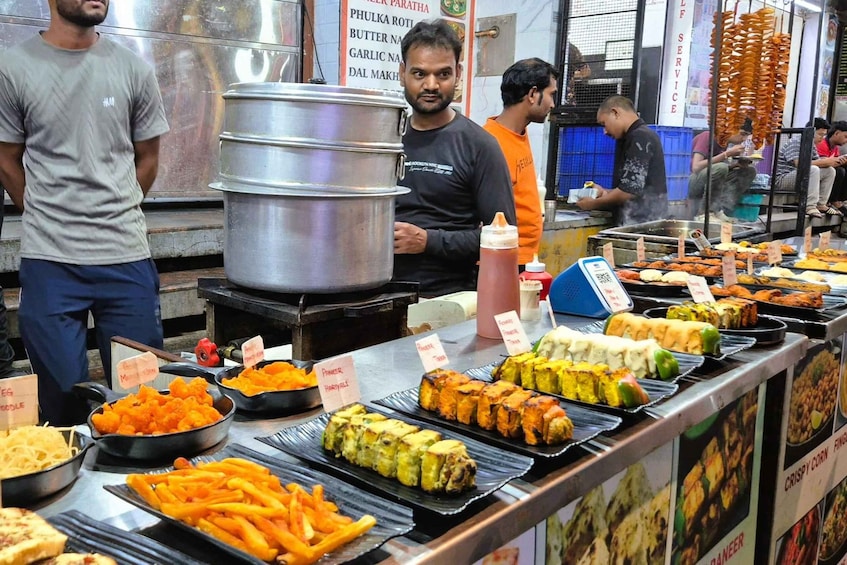 A food stall with various dishes and cooking equipment. 5