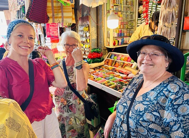 A market stall with colorful fabrics and accessories. 4