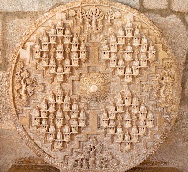 A detailed stone carving with symmetrical patterns and central motifs. 4