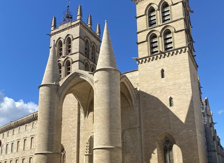A historic cathedral with two prominent towers and large arches. 5