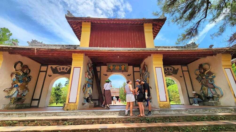 A traditional temple with ornate carvings and a red roof. 5