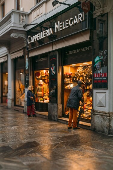 A street with a shop named CAPPELLERIA MELEGARI displaying hats and accessories. 3
