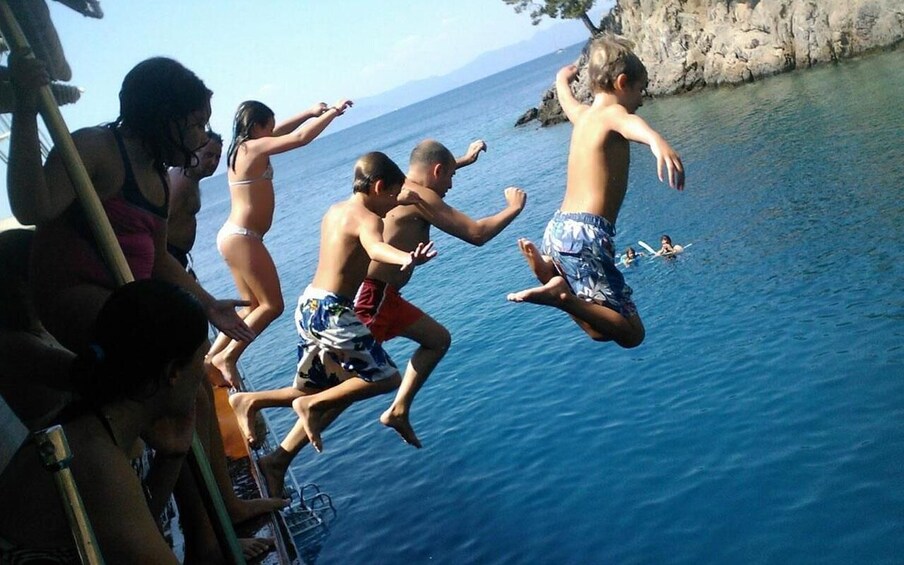 People jumping into the sea from a boat. 1