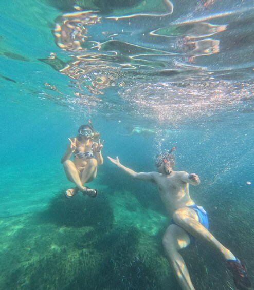 Two people snorkeling underwater. 5