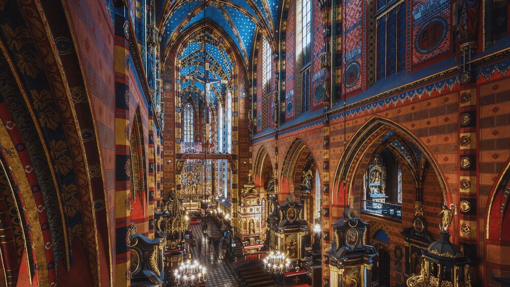 An ornate church interior with intricate stained glass windows and detailed brickwork. 1