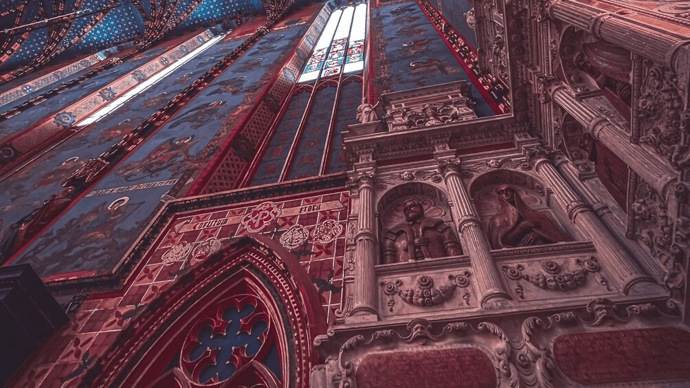 A detailed view of a cathedral's interior with ornate stained glass windows and intricate stone carvings. 5