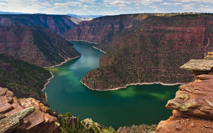A canyon with a river and a small island. 1