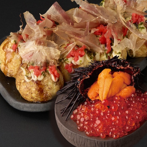 A variety of food items including breaded and fried items, a bowl of red caviar, and a dish with a creamy sauce and diced tomatoes. 4