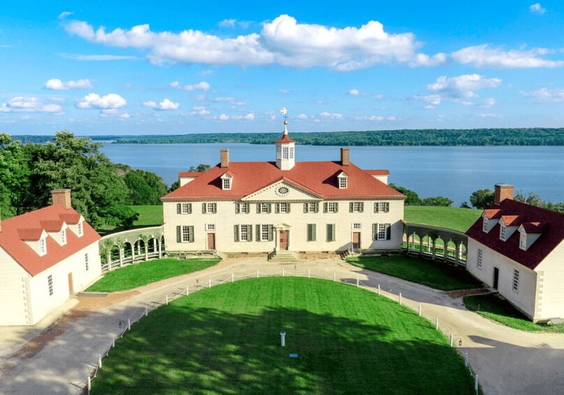 A large estate with a central building, a lake, and surrounding greenery. 1