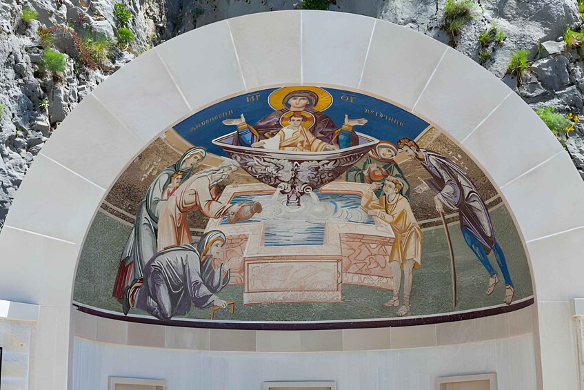 A mosaic with religious figures and a central figure in a boat, surrounded by people. 3