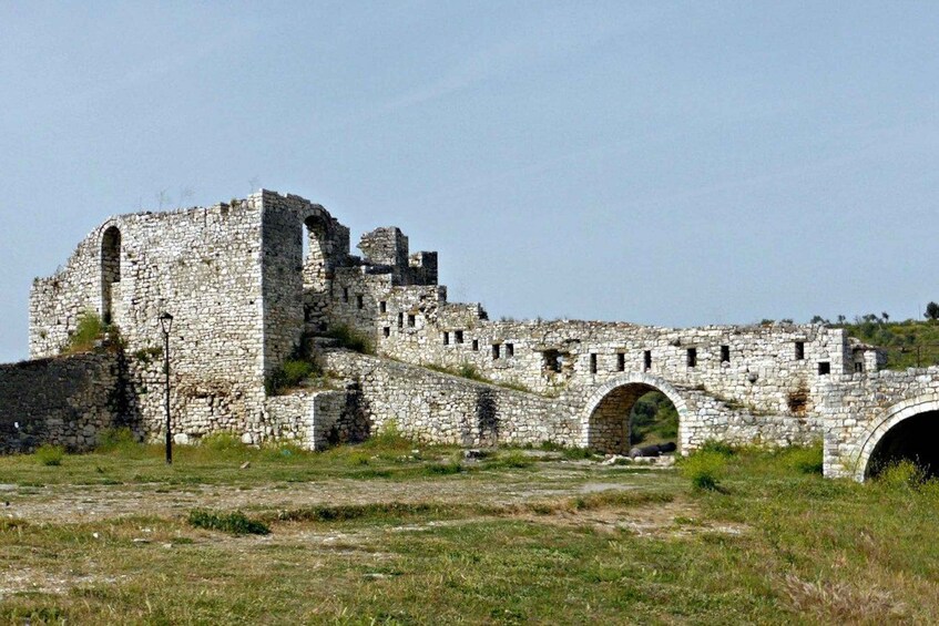 An ancient stone structure with arches and ruins. 3