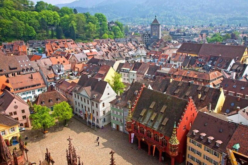 A historic town with colorful buildings and a prominent clock tower. 4