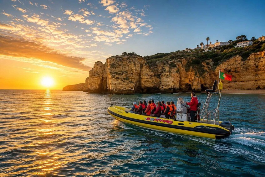 A yellow boat with passengers, a sunset, and rocky cliffs. 1