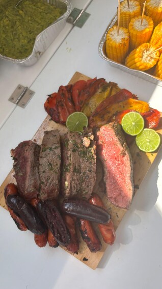 A charcuterie board with various meats, including steak and sausages, and a side of grilled vegetables. 3