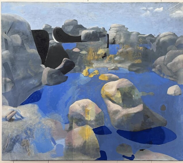 A landscape with large rocks and a body of water. 2