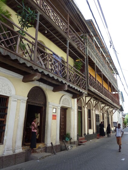 A traditional building with ornate balconies and a street in front. 3