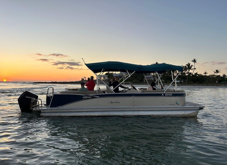 A boat with a canopy, people on board, and a sunset in the background. 5