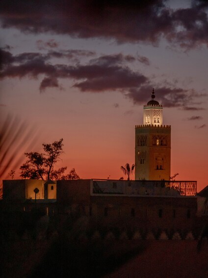A tower with a dome and minarets at sunset. 4