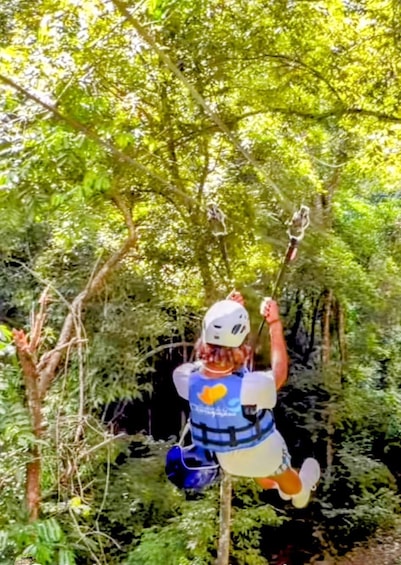 A person zip-lining through a forest. 1