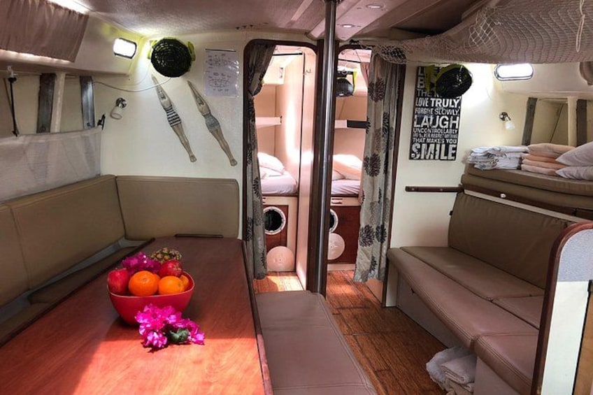 A compact interior with a bunk bed, a small table with fruit, and a wall with motivational quotes. 2