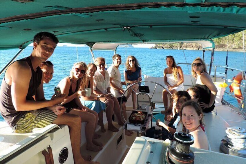 Eine Gruppe von Menschen auf einem Boot mit freier Sicht auf das Wasser und das entfernte Land. 2