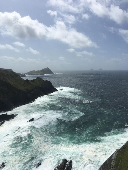 A rugged coastline with turbulent waves crashing against steep cliffs. 5