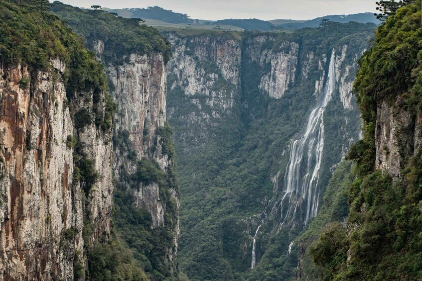 A canyon with multiple waterfalls and steep cliffs. 3